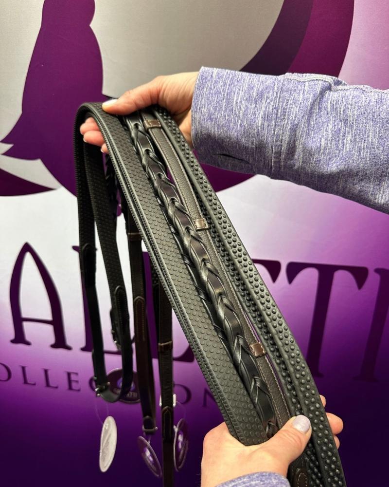 cavaletti-collection-black-leather-reins-selection.jpg Hands holding a selection of Cavaletti Collection black leather reins, including plaited, rubber grip and laced styles