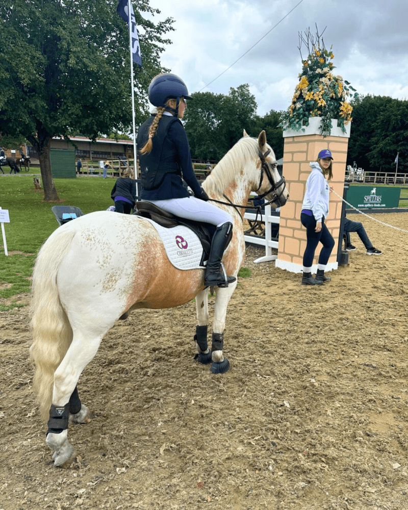Rider on a skewbald pony wearing a Cavaletti Collection saddle pad at the SEIB Trailblazers Championships