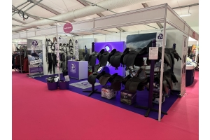 Cavaletti Collection trade stand displaying black saddles, bridles, and branded signage at an equestrian event.